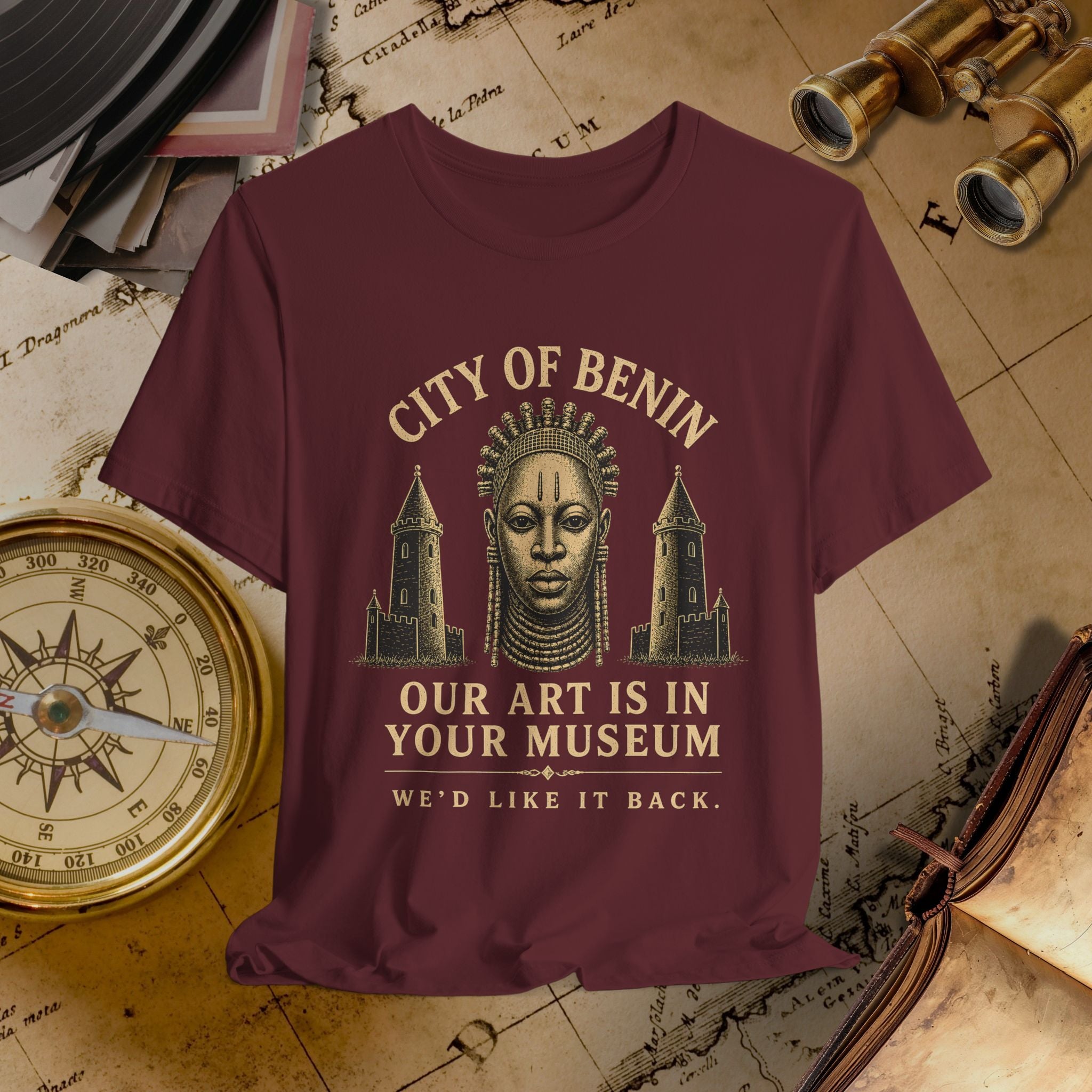 Maroon t-shirt with 'City of Benin' graphic and text on a vintage map background