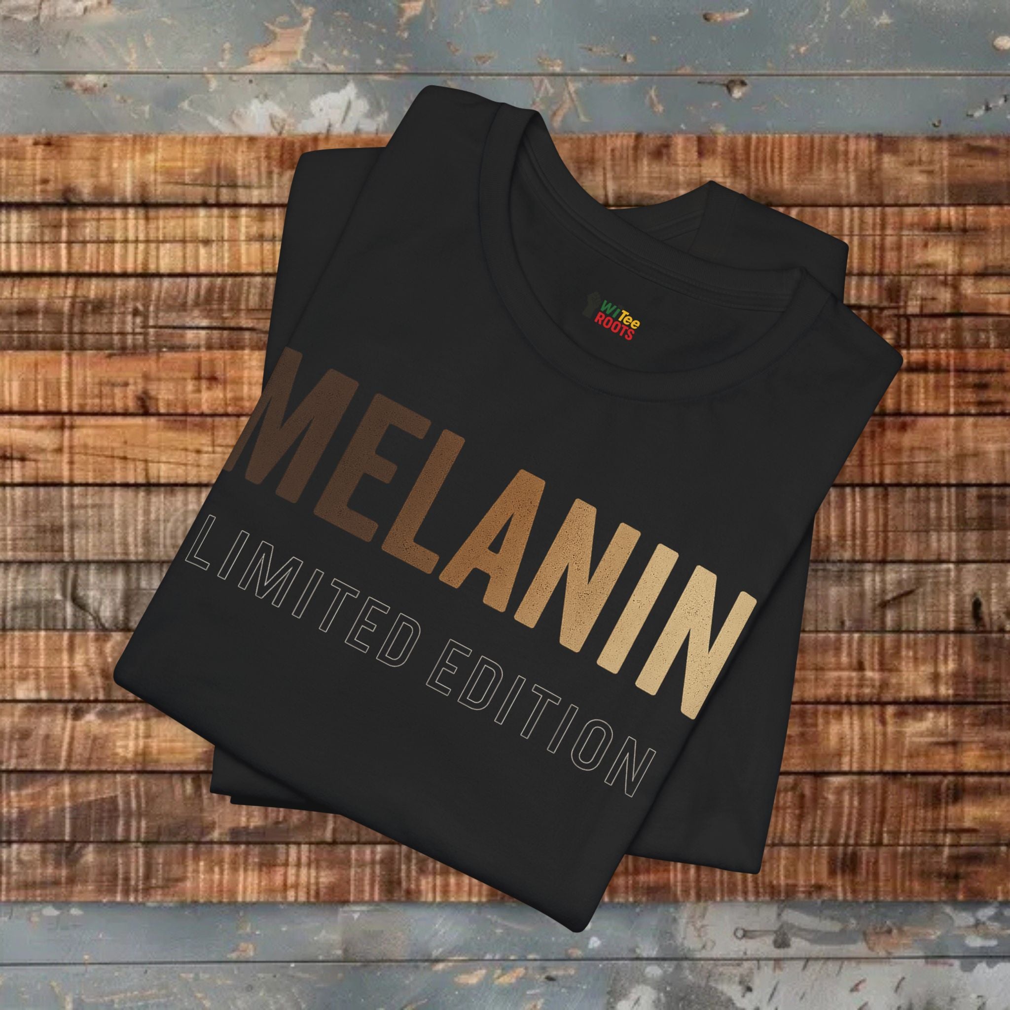 Black t-shirt with 'MELANIN LIMITED EDITION' text on a wooden surface