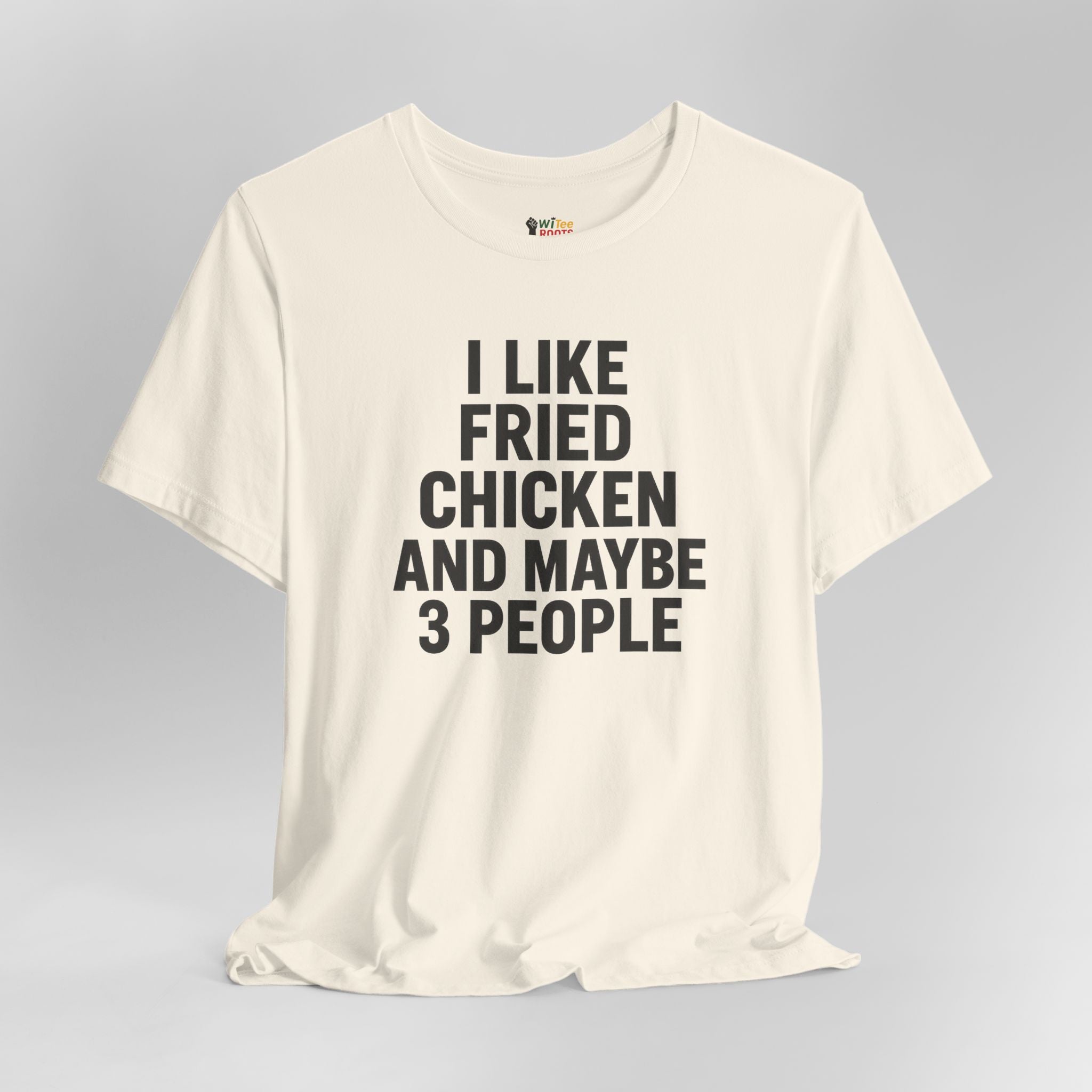 Cream t-shirt with black text 'I LIKE FRIED CHICKEN AND MAYBE 3 PEOPLE' on a gray background