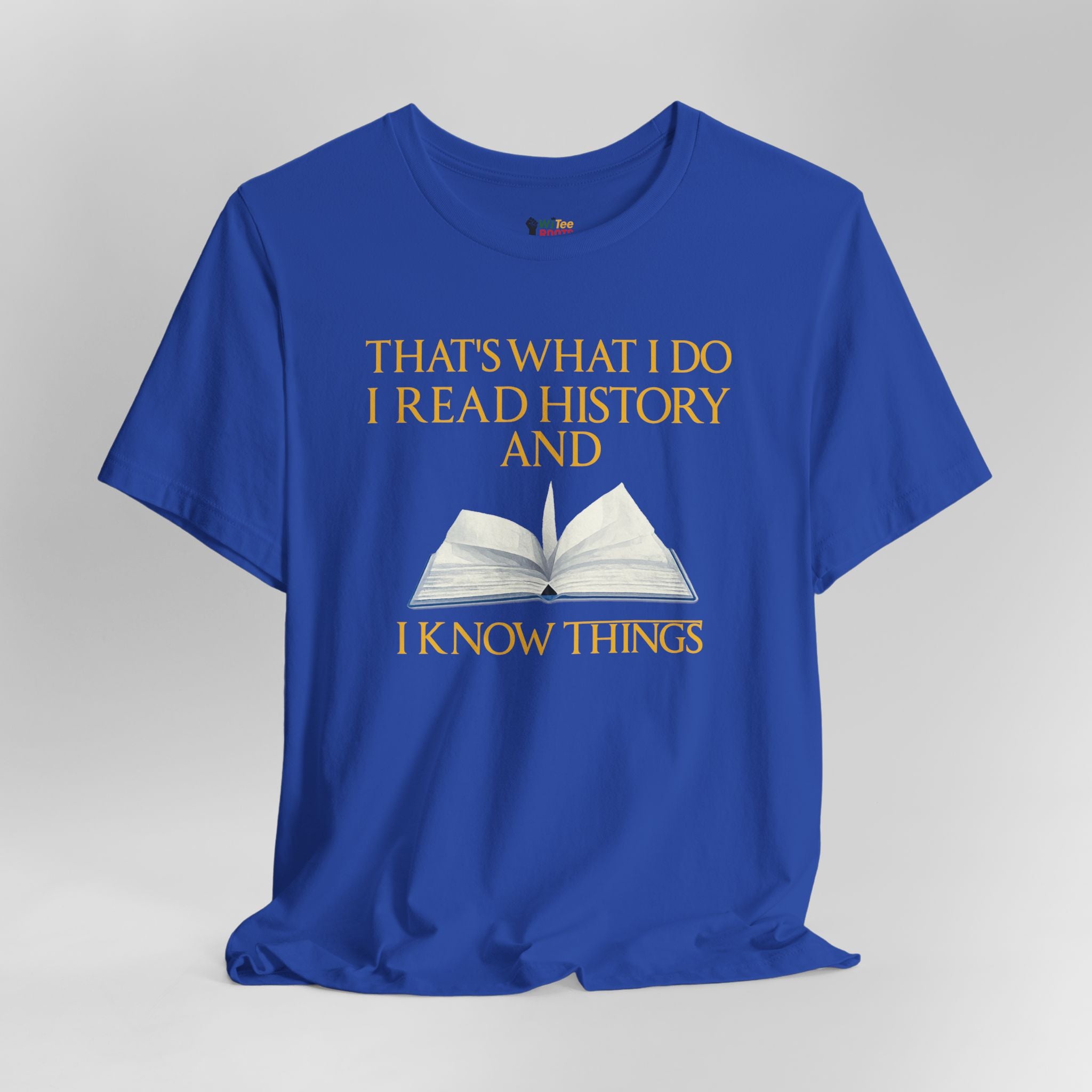 Blue t-shirt with yellow text and an open book graphic on a gray background