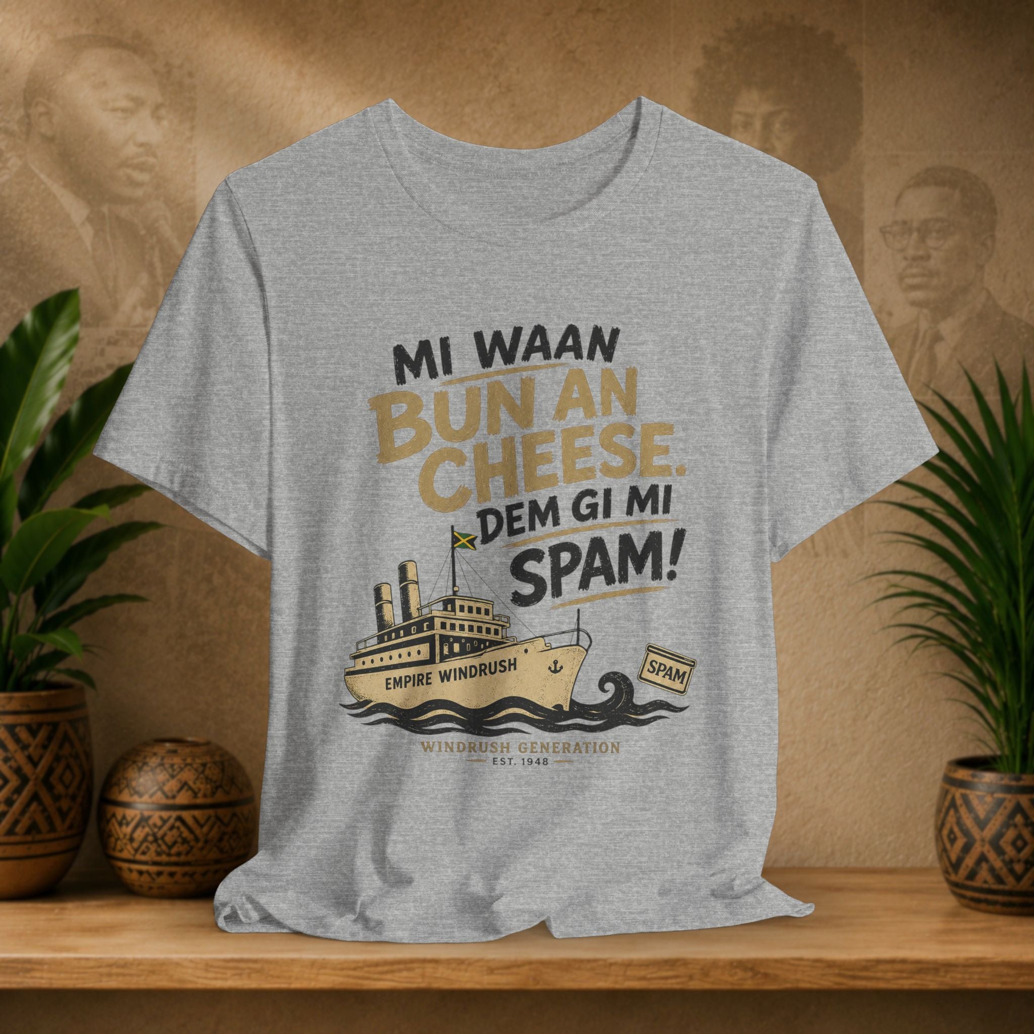 Grey t-shirt with graphic design and text on a wooden shelf with plants and a brown background