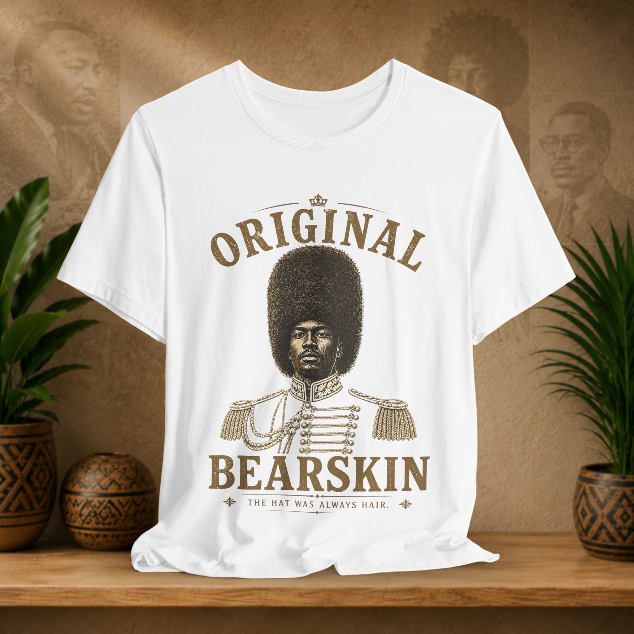 White t-shirt with 'Original Bearskin' graphic on a wooden surface with plants and a textured wall background