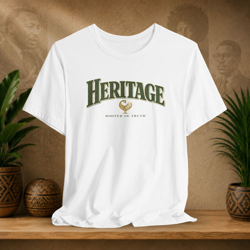 White t-shirt with 'Heritage' text on a wooden shelf with plants and a textured wall background
