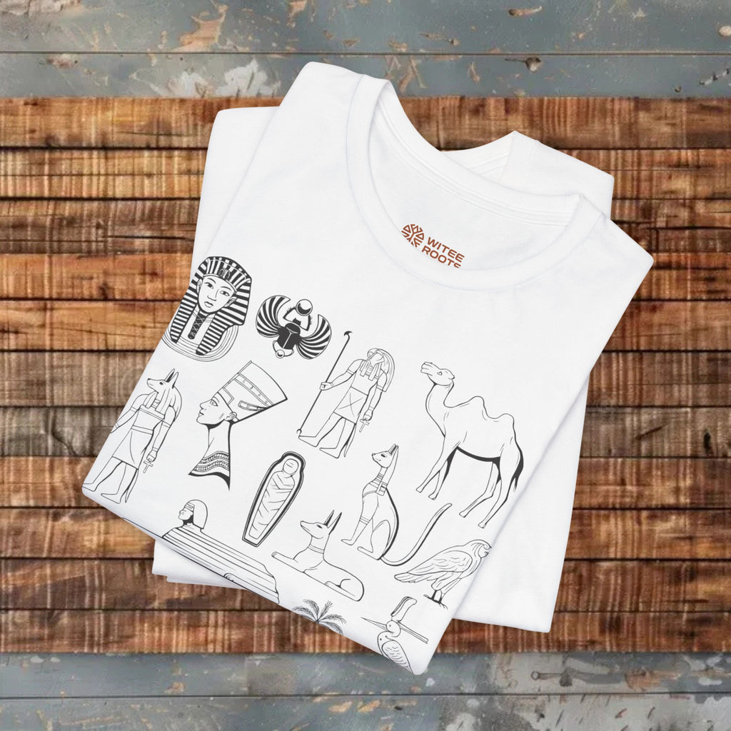White t-shirt with Egyptian-themed designs on a wooden surface