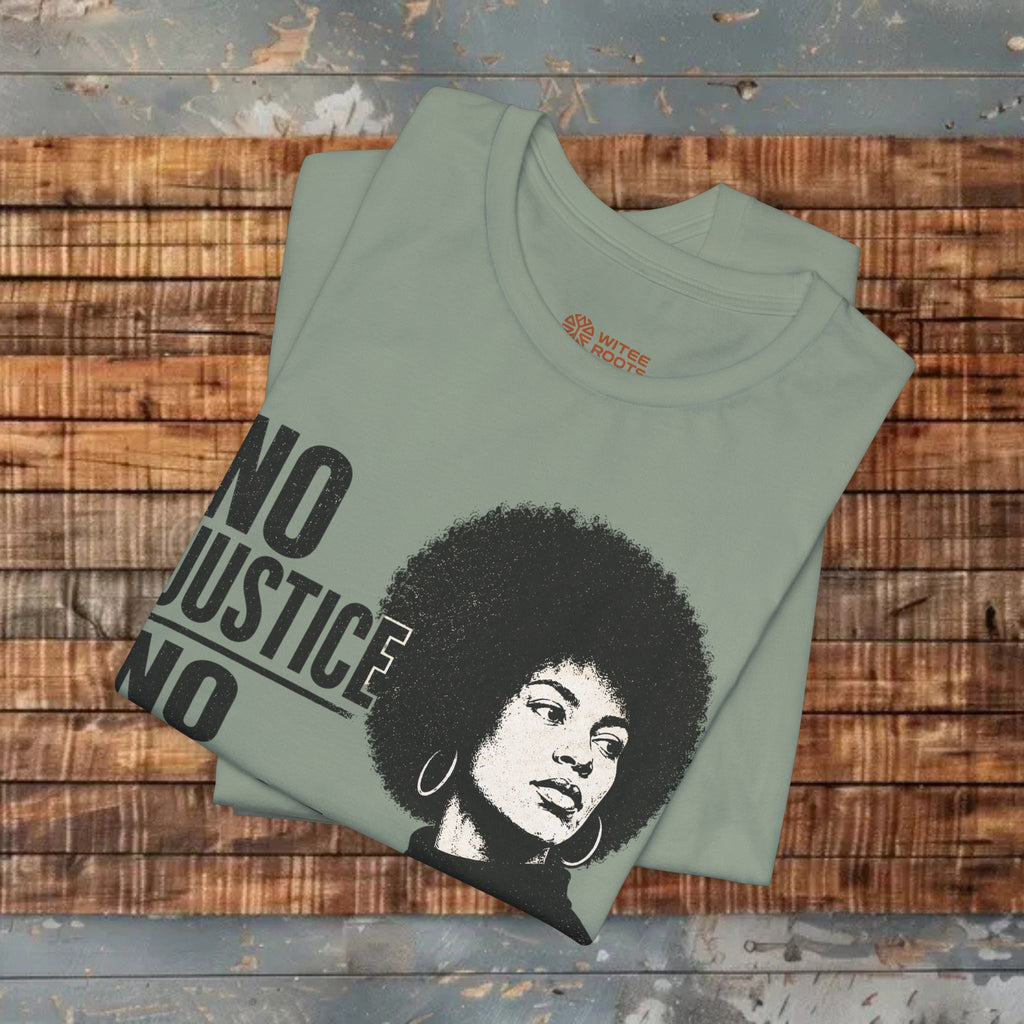 Folded green t-shirt with a graphic and text on a wooden surface