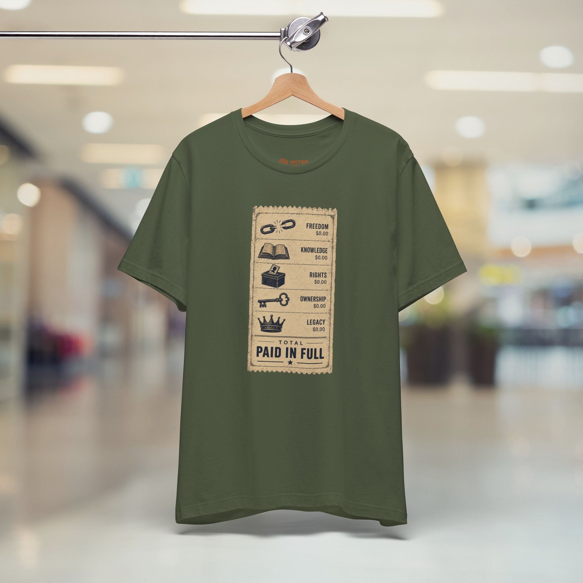 Green t-shirt with graphic design on a hanger in a store setting
