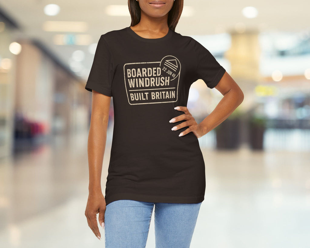 Woman wearing a Brown t-shirt with text in a blurred indoor setting