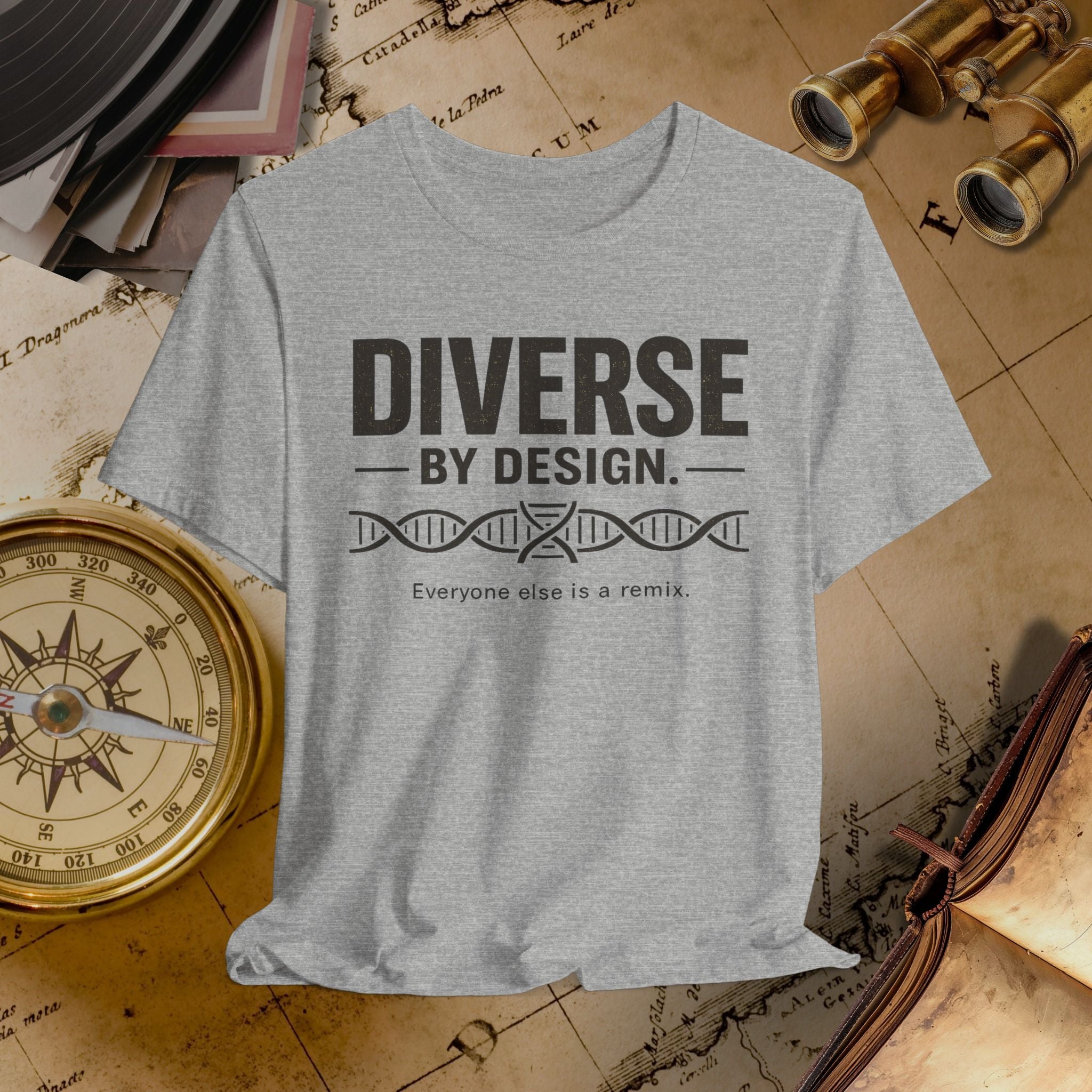 Grey t-shirt with 'Diverse by Design' text on a vintage map background