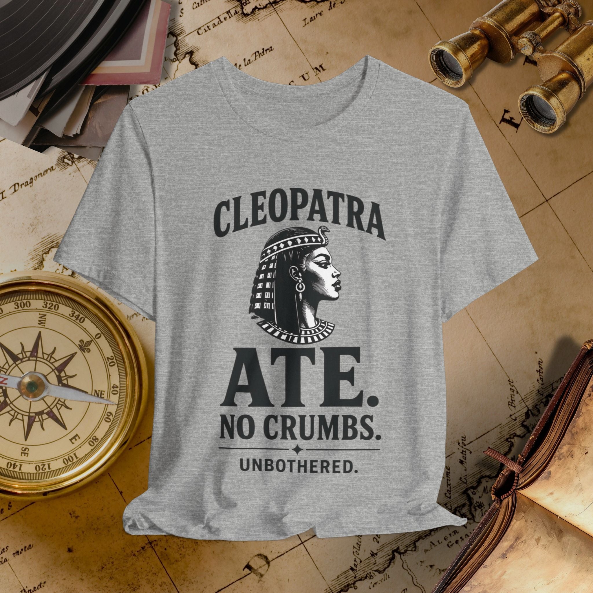 Gray t-shirt with Cleopatra graphic and text on a vintage map background