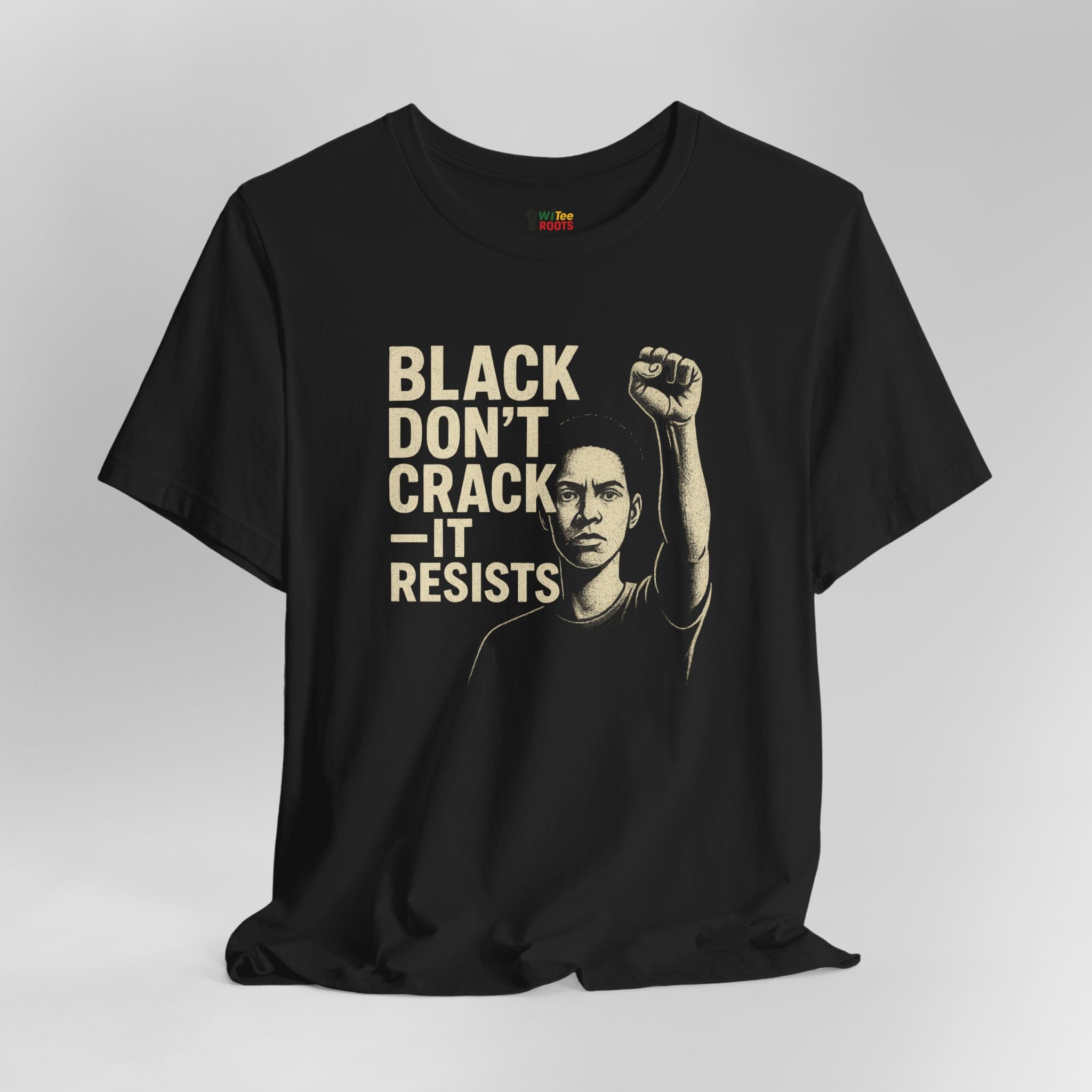 Black t-shirt with graphic of a person raising a fist and text 'BLACK DON'T CRACK IT RESISTS' on a light gray background