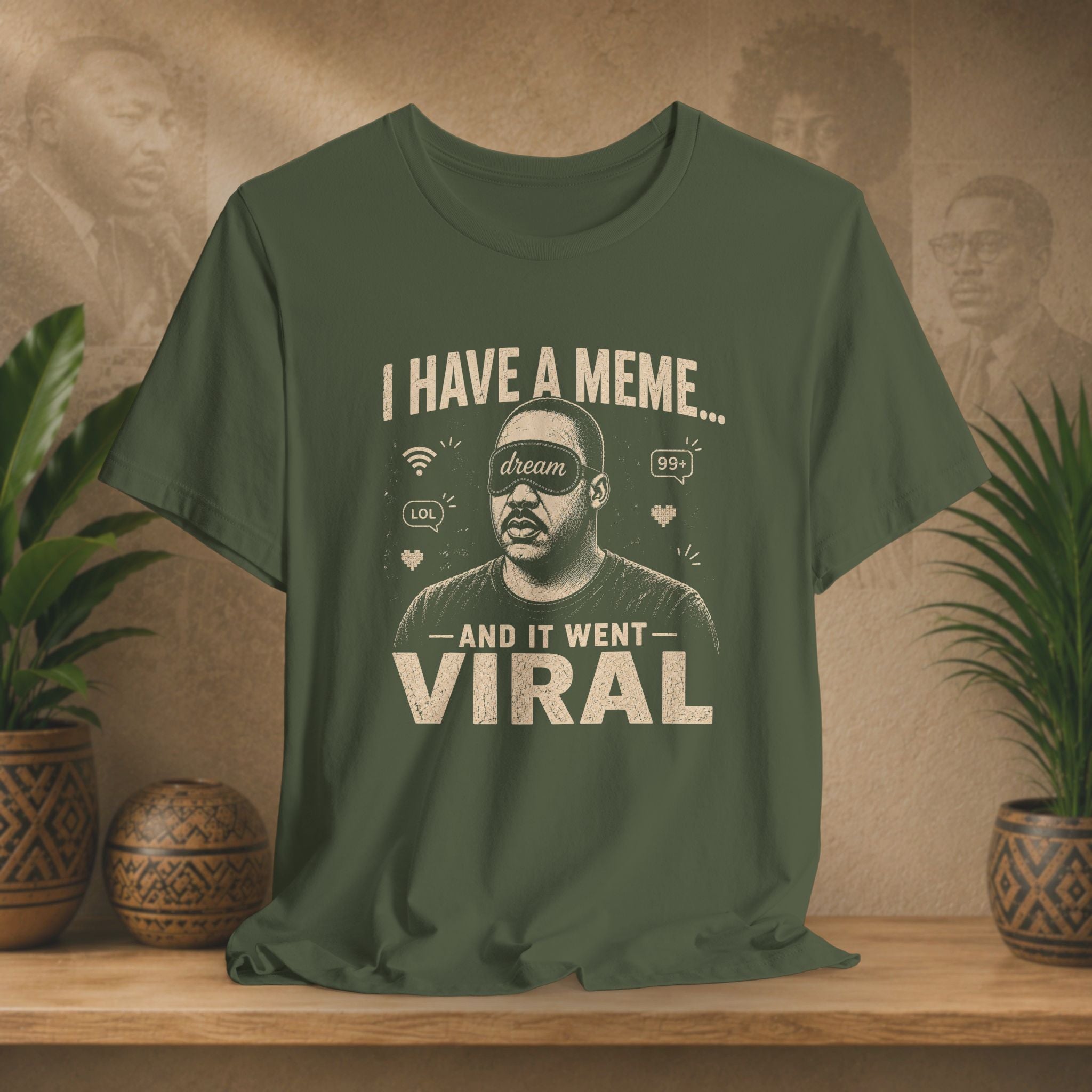 Green t-shirt with a graphic and text on a wooden surface with plants and a wall in the background