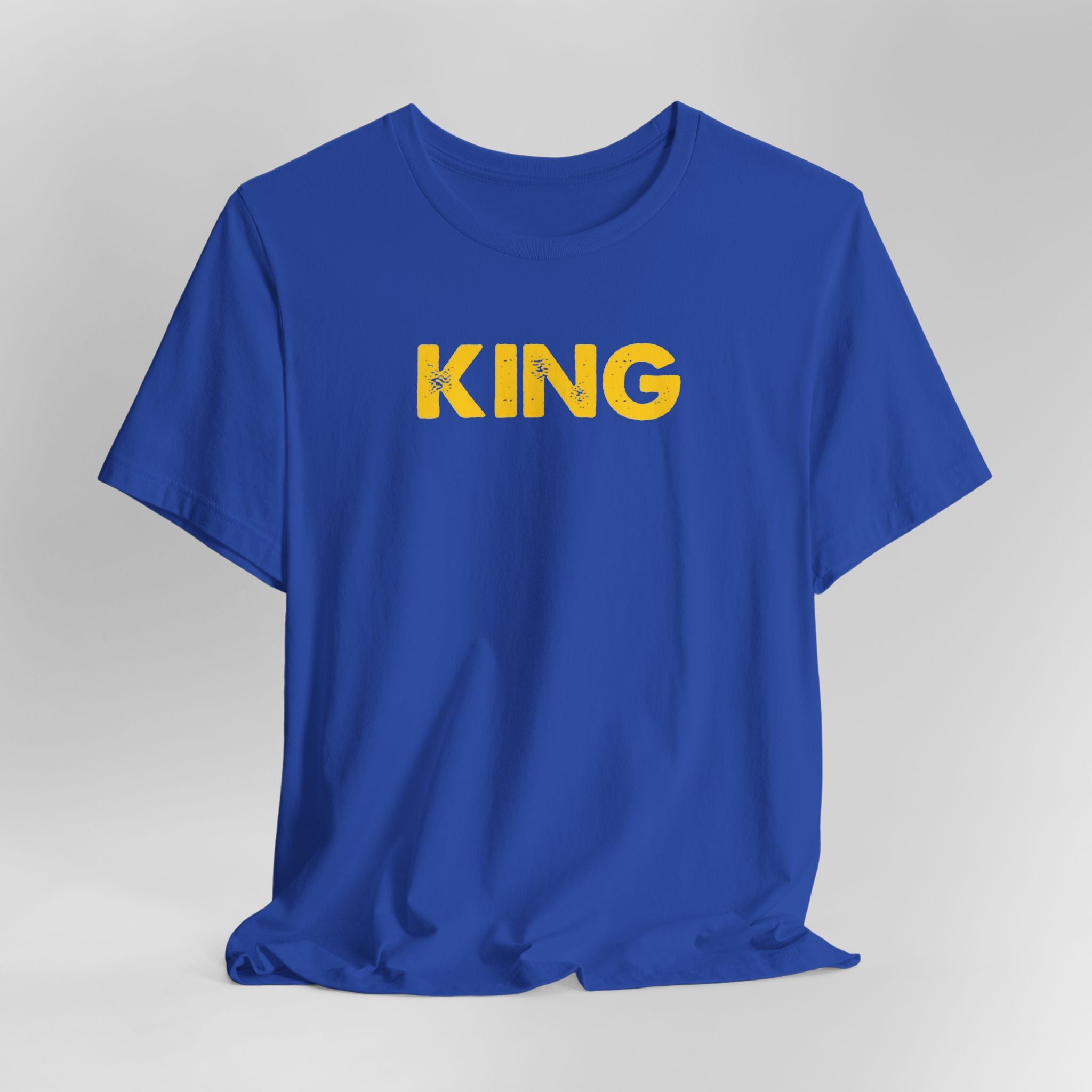 Blue t-shirt with 'KING' printed in yellow on a gray background