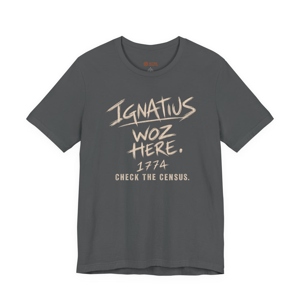 A dark gray crewneck t-shirt with a distressed beige graphic print on the front reading 'IGNATIUS WOZ HERE. 1974 CHECK THE CENSUS.