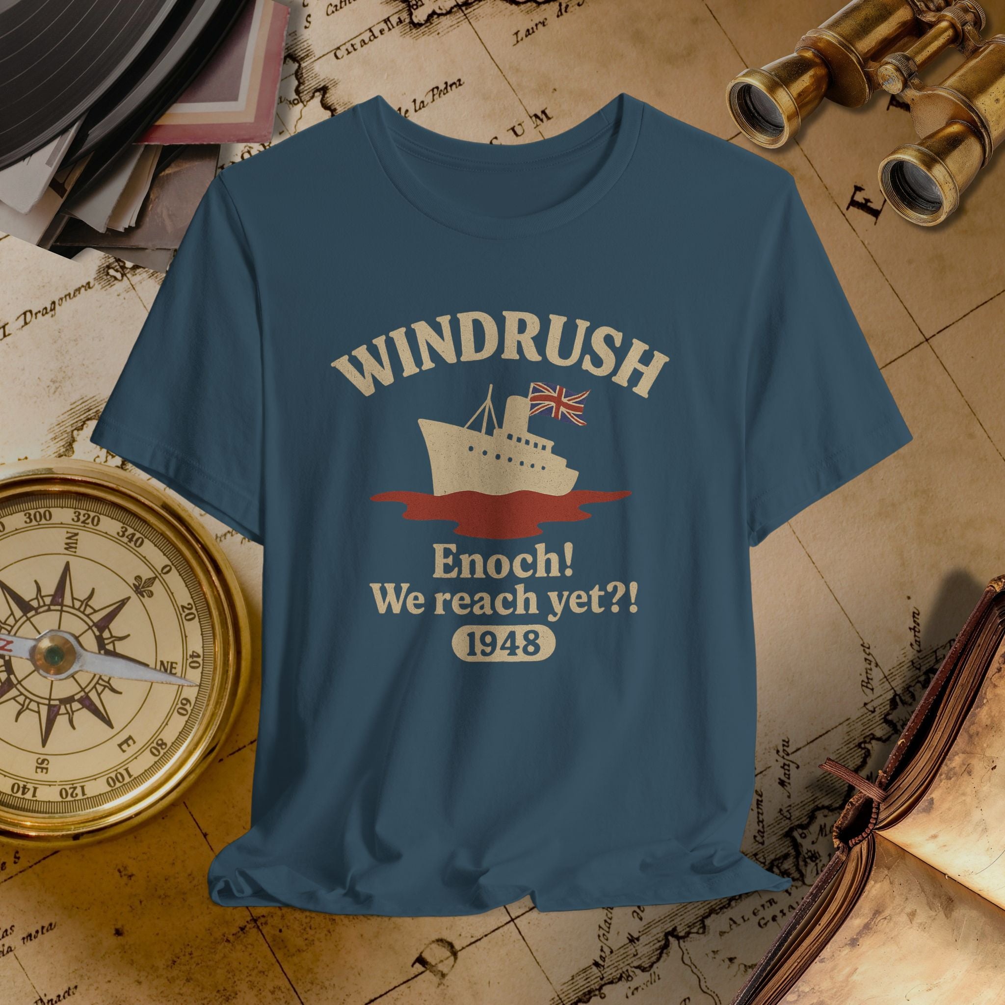 Blue t-shirt with 'Windrush' design on a vintage map background