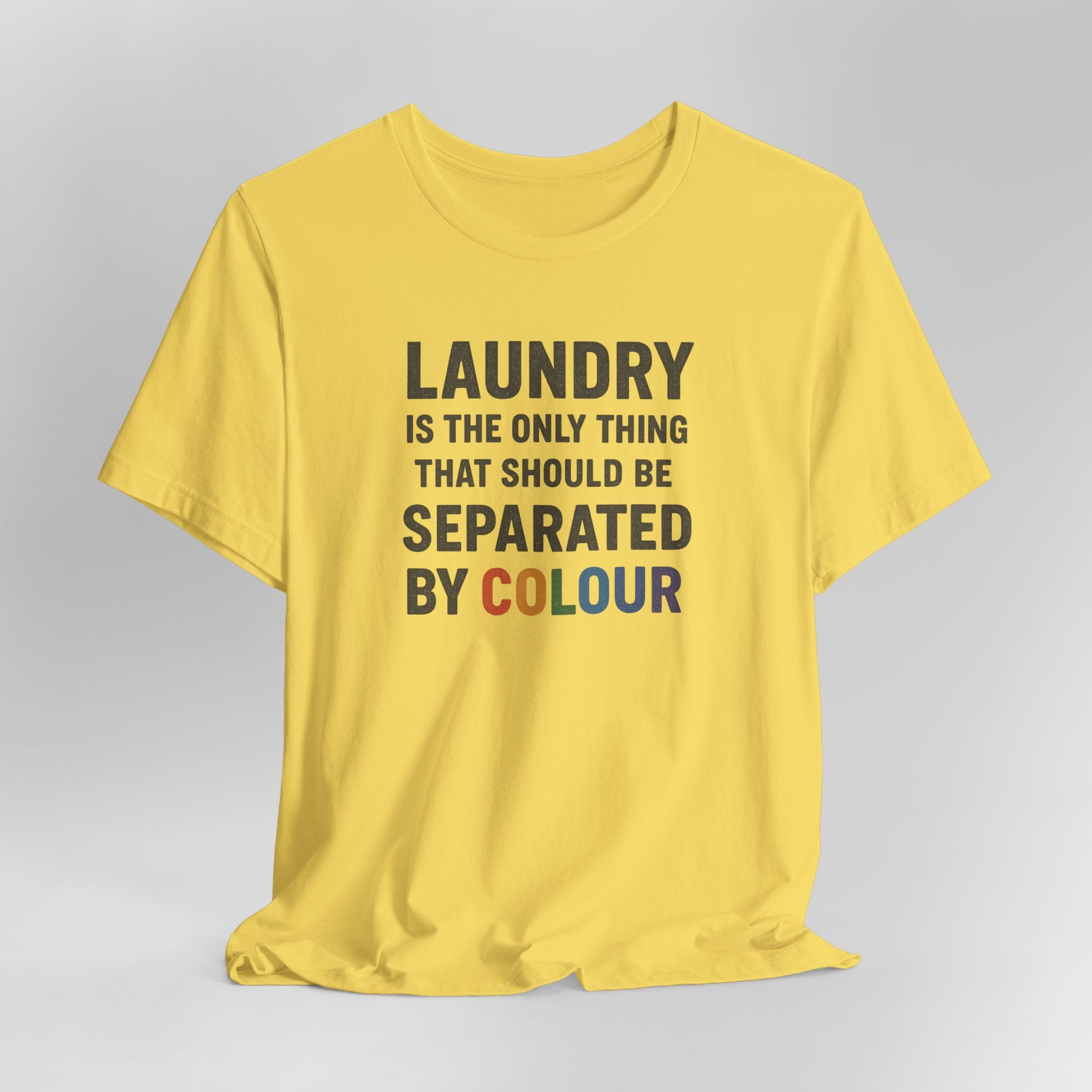 Mustard t-shirt with humorous text design on a gray background