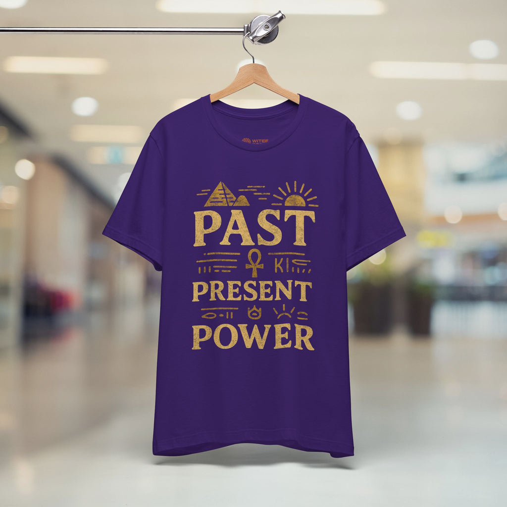 Purple t-shirt with gold text on a hanger in a store setting