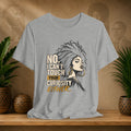 A heather gray graphic t-shirt displayed on a wooden shelf. The shirt features a stylized illustration of a Black woman with an afro and gold hoop earrings next to the text 'NO, I CAN'T TOUCH YOUR CURIOSITY EITHER.