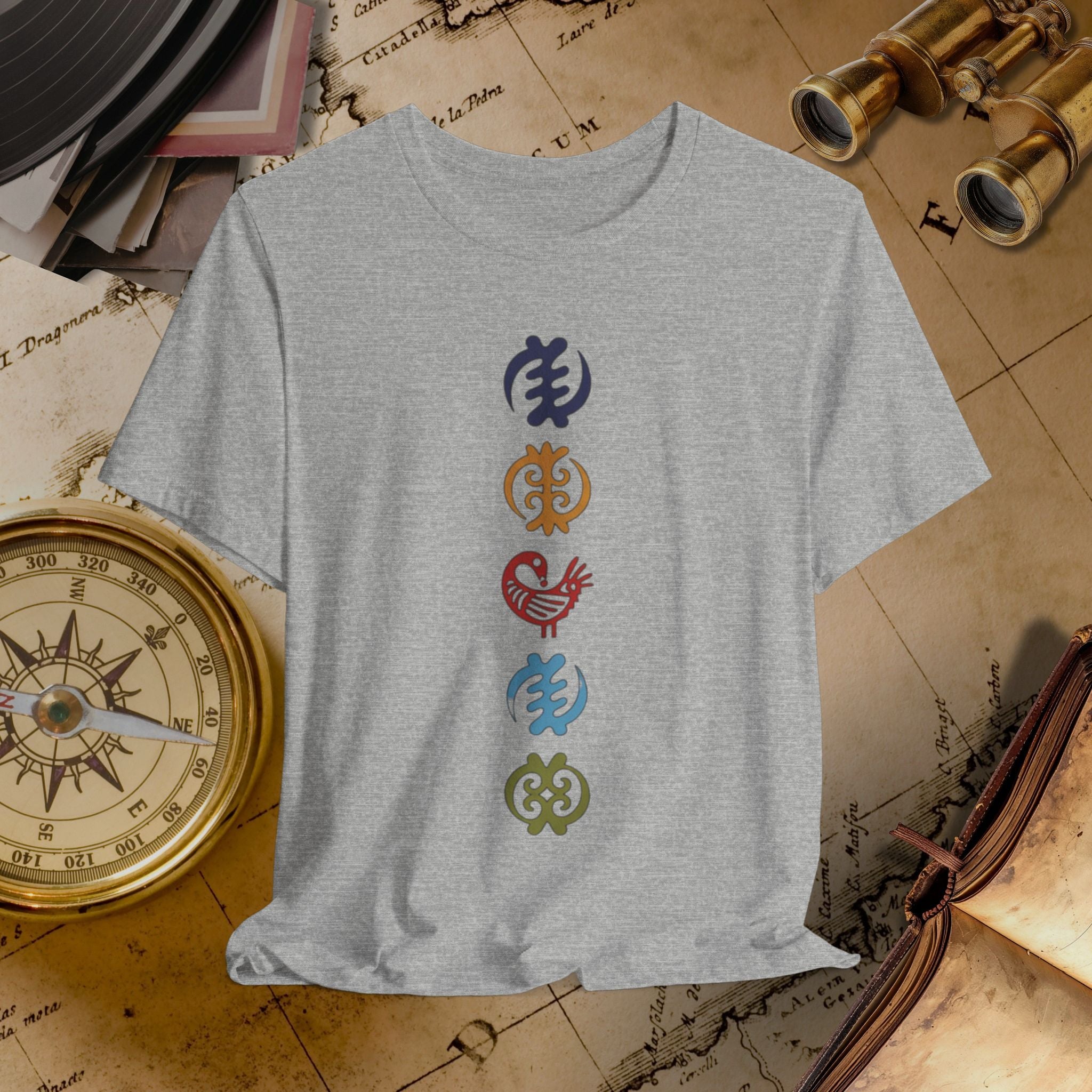 Gray t-shirt with colorful symbols on a vintage map background